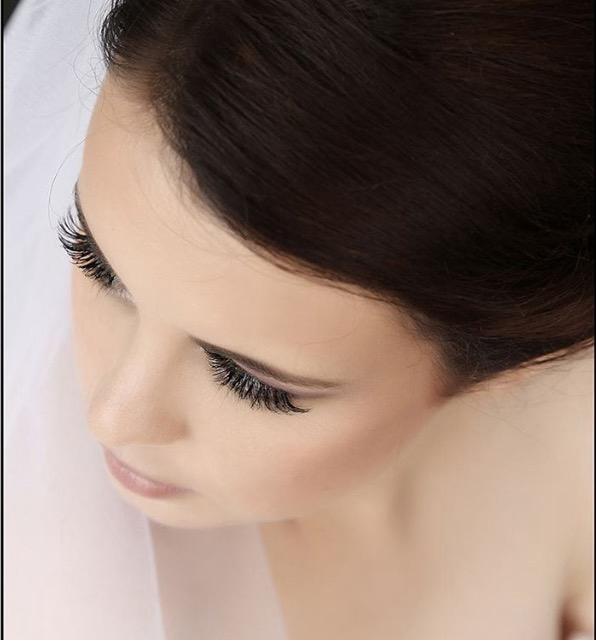 Close-up bridal lashes and veil detail